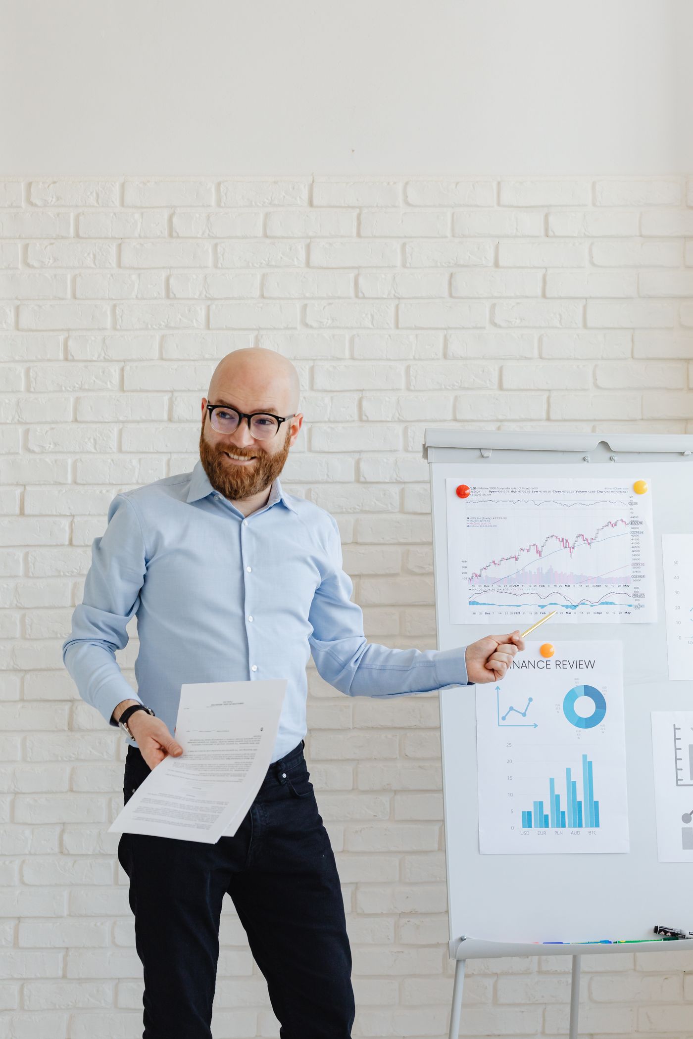 Financial analyst pointing at a performance chart